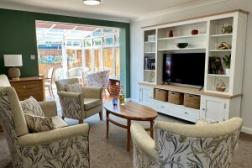 Lounge showing armchairs, tv unit and looking through to a conservatory
