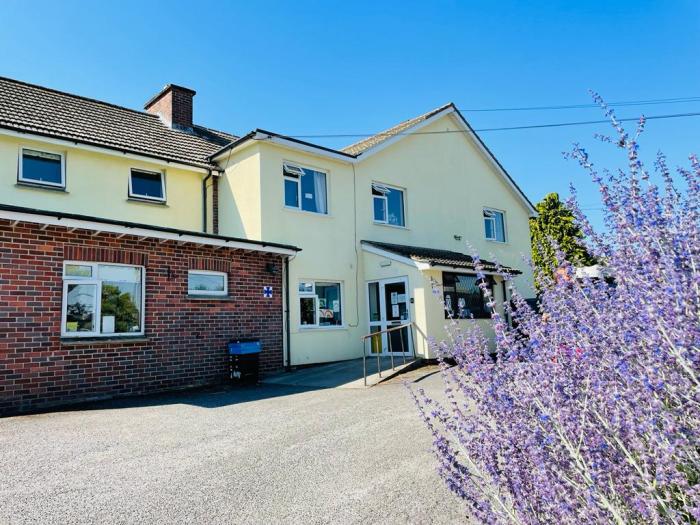Photo shows entrance to Bramble Down Nursing home with pretty lavender in forefront
