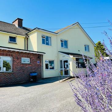 Photo shows entrance to Bramble Down Nursing home with pretty lavender in forefront
