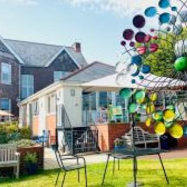 Photo shows Parkland House garden with colourful sculptures